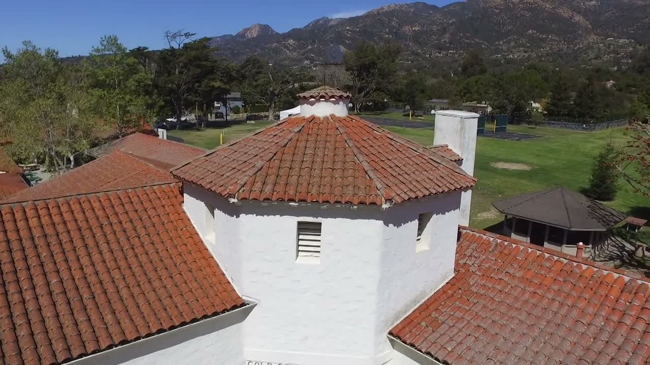 The tiled turret roof of Cold Spring School with the Santa Ynez Mountains behind