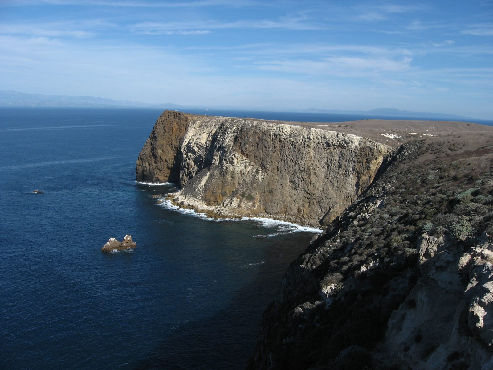 The rocky coastline of Santa Cruz Island rising from blue water