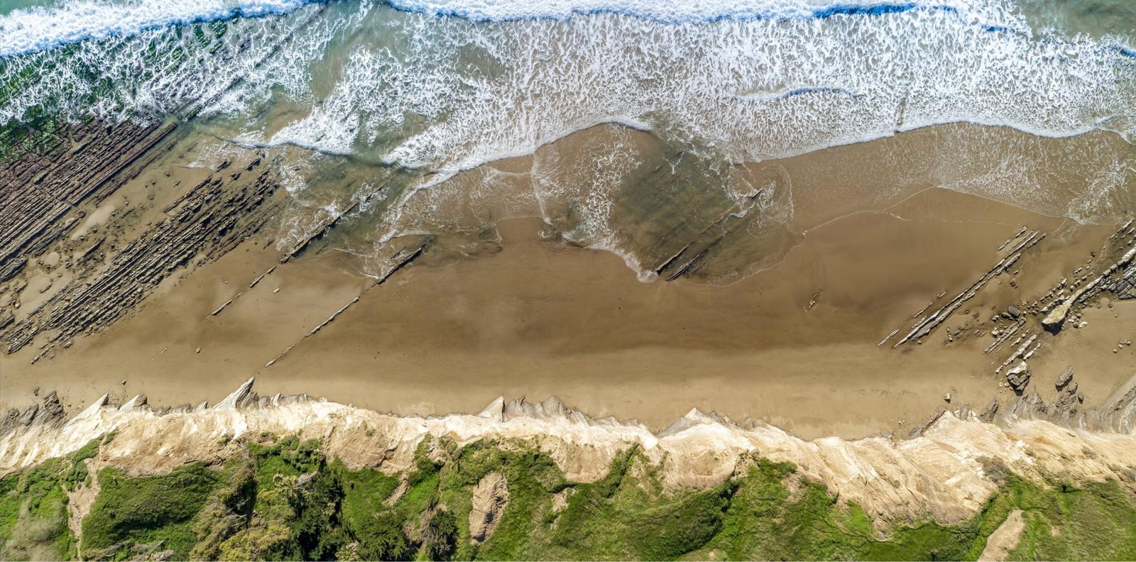 Waves break over the reef at Naples. The property adjoins the Naples State Marine Conservation Area, and the Land Trust says protecting it would preserve a rare connection between land and sea.