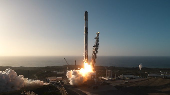 A SpaceX Falcon 9 lifting off from Space Launch Complex 4-East at Vandenberg Space Force Base at dusk, the Pacific Ocean behind the pad