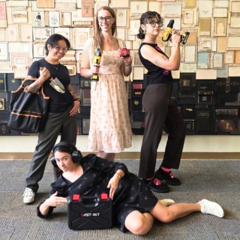Library staff posing with drills, a trowel and a tool case in the library's own launch photograph. Thursday's launch party runs from 4 to 6 p.m. in the Faulkner Gallery.